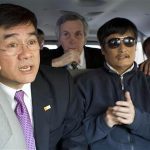 A handout photo from the U.S. Embassy Beijing Press office shows U.S. Ambassador to China Gary Locke (L) talking on a mobile phone as he accompanies blind activist Chen Guangcheng (R) in a car, in Beijing, May 2, 2012. Picture taken May 2, 2012. REUTERS/US Embassy Beijing Press Office/Handout