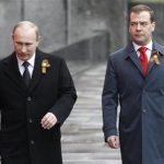 Russian President Vladimir Putin and Prime Minister Dmitry Medvedev arrive for the Victory Parade on Moscow's Red Square May 9, 2012. REUTERS/Sergei Karpukhin