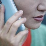 A North Korean defector living in South Korea who requested to be known only by surname, Im, and her whole face not to be photographed, uses her mobile phone during an interview at her office in Seoul May 25, 2012. REUTERS/Lee Jae-Won