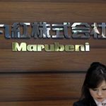 A receptionist works in front of the logo of Japanese trading house Marubeni Corp at the company's headquarters in Tokyo in this May 29, 2012 file photograph. REUTERS/Yuriko Nakao