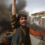 An Afghan protester shouts slogans near burning tyres during a demonstration in Kabul September 17, 2012. REUTERS/Omar Sobhani