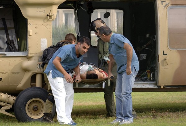 A man wounded by rocket fire is carried out of a helicopter by hospital workers upon arrival at Soroka hospital in the southern Israeli city of Beersheba October 24, 2012