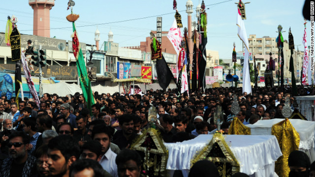 Pakistani Shiite Muslims march during a religious procession on the ninth day of holy month of Moharram in Karach