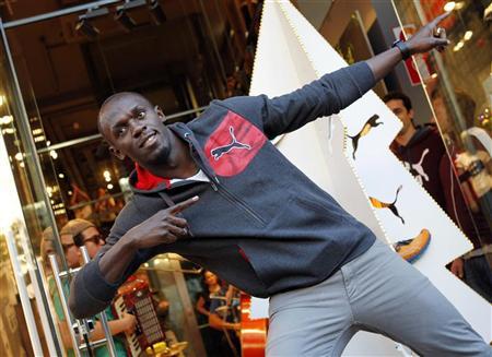 Jamaica's double Olympic champion sprinter Usain Bolt strikes a pose while inaugurating a Puma store in Barcelona November 23, 2012. REUTERS/Albert Gea