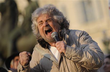 Five-Star Movement leader and comedian Beppe Grillo gestures during a rally in Turin in this February 16, 2013 file photo. ITALY-ELECTION/ REUTERS/Giorgio Perottino/Files