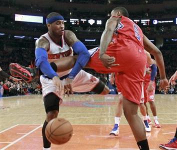 New York Knicks forward Carmelo Anthony (7) tries to pass against Los Angeles Clippers center DeAndre Jordan (6) in the first quarter of their NBA basketball game at Madison Square Garden in New York, February 10, 2013. REUTERS/Ray Stubblebine (UNITED STATES - Tags: SPORT BASKETBALL)