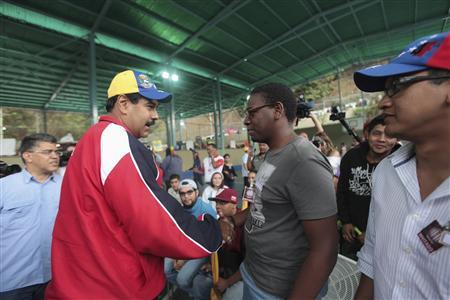 Venezuela's acting President Nicolas Maduro (L) greets supporters during the inauguration ceremony of a court at Petare neighbourhood in Caracas March 17, 2013 in this handout picture provided by the Miraflores Palace. REUTERS/Miraflores Palace/Handout