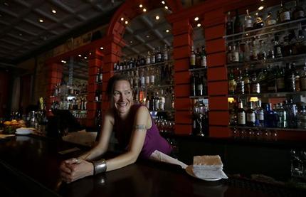 Bartender Valen West smiles while speaking to reporter at Zare at Fly Trap in San Francisco, Wednesday, April 3, 2013. Across California, 2 a.m. is the witching hour for bartenders to issue the last call for drinks. But a proposed state law would give nightlife loving cities the option of allowing their bars and clubs to keep serving drinks for two more hours. (AP Photo/Jeff Chiu)