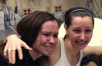 Amanda Berry, right, hugs her sister Beth Serrano after being reunited in a Cleveland hospital Monday May 6, 2013. Berry and two other women were found in a house near downtown Cleveland Monday after being missing for about a decade. (AP Photo/Family Handout courtesy WOIO-TV)