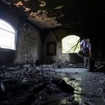 FILE - In this Thursday, Sept. 13, 2012 file photo, a Libyan man investigates the inside of the U.S. Consulate after an attack that killed four Americans, including Ambassador Chris Stevens, on the night of Tuesday, Sept. 11, 2012, in Benghazi, Libya. House Republicans insist the Obama administration is covering up information about the deadly assault on the U.S. diplomatic mission in Benghazi, Libya, last year, rejecting administration assurances to the contrary and stoking a controversy with implications for the 2016 presidential race. (AP Photo/Mohammad Hannon, File)