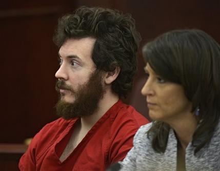 FILE - In this March 12, 2013 file photo, James Holmes, left, and defense attorney Tamara Brady appear in district court in Centennial, Colo. for his arraignment. Lawyers for Holmes, the man accused of killing 12 people and injuring 70 in a Colorado movie theater, said Tuesday May 7, 2013 he wants to change his plea to not guilty by reason of insanity. (AP Photo/The Denver Post, RJ Sangosti, Pool, File)