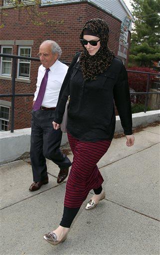 FILE - In this April 29, 2013 file photo, Katherine Russell, wife of Boston Marathon bomber suspect Tamerlan Tsarnaev, right, leaves the law office of DeLuca and Weizenbaum with Amato DeLuca, in Providence, R.I. Relatives of Tsarnaev, the older of the brothers suspected in the Boston Marathon bombing, will claim his body now that his wife has agreed to release it, an uncle said as officials in the U.S. and Russia deepened their investigations into him. (AP Photo/Stew Milne, File)