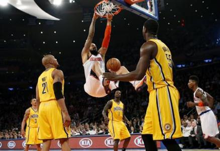 New York Knicks' Tyson Chandler (C) dunks past Indiana Pacers' David West (L) and Roy Hibbert (R) during the second quarter in Game 2 of their NBA Eastern Conference playoff basketball series in New York May 7, 2013. The Knicks won the game 105-79. REUTERS/Mike Segar