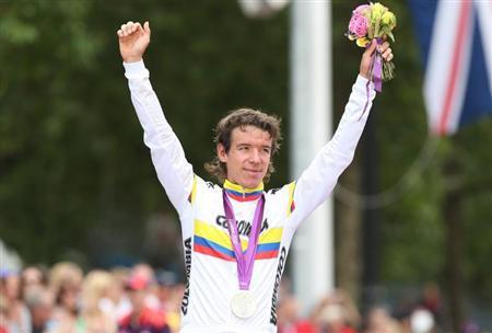 Silver medalist Rigoberto Uran of Colombia celebrates during the victory ceremony after the men's cycling road race at the London 2012 Olympic Games July 28, 2012. REUTERS/Stefano Rellandini