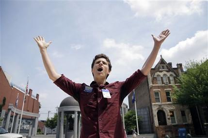 FILE - Christian Olivera, of Newark, N.J., shouts toward the Statehouse in Trenton, N.J. on Thursday, June 27, 2013 as he and other advocates for gay marriage in New Jersey gather, saying they'll press their case in the legislature and the courts after the U.S. Supreme Court ruling that invalidates parts of the federal Defense of Marriage Act. Gov. Chris Christie said he would again veto a same-sex marriage bill if it reaches his desk, and that Wednesday's U.S. Supreme Court ruling striking down a ban on federal benefits for same-sex married couples will have no effect on New Jersey, one of a handful of states that allows civil unions. (AP Photo/Mel Evans)