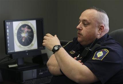 In this Tuesday, April 2, 2013 photo shows Brimfield Police Chief David Oliver talking about his facebook page in Kent, Ohio. Oliver uses the reach of his departments increasingly followed Facebook page to interact with residents and take to task criminals and other neer-do-wells, his preferred term is mopes, for the stupid, the silly and the outright unlawful in messages that mix humor and blunt opinion. (AP Photo/Tony Dejak)