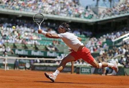 Rafael Nadal of Spain hits a return to Novak Djokovic of Serbia during their men's singles semi-final match at the French Open tennis tournament at the Roland Garros stadium in Paris June 7, 2013. REUTERS/Gonzalo Fuentes