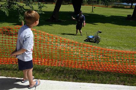 Five-year-old Brady Chapman watches a robot from Kuukulgur team from Estonia compete in NASA's 2013 Sample Return Robot Challenge at the Worcester Polytechnic Institute in Worcester, Massachusetts June 5, 2013. REUTERS/Brian Snyder