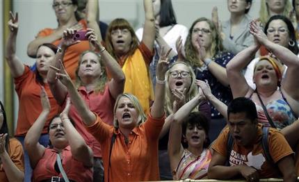 Members of the gallery cheer and chant as the Texas Senate tries to bring an abortion bill to a vote as time expires, Wednesday, June 26, 2013, in Austin, Texas. Amid the deafening roar of abortion rights supporters, Texas Republicans huddled around the Senate podium to pass new abortion restrictions, but whether the vote was cast before or after midnight is in dispute. If signed into law, the measures would close almost every abortion clinic in Texas. (AP Photo/Eric Gay)