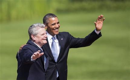 US President Barack Obama, right, waves next to German President Joachim Gauck after he was welcomed with military honors at the presidential residence Bellevue castle in Berlin, Germany, Wednesday, June 19, 2013. On the second day of his visit to Germany Obama is meeting with German President Gauck and German Chancellor Angela Merkel before delivering a speech at Brandenburg Gate. (AP Photo/Gero Breloer)