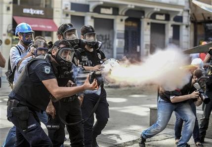 Police fire tear gas as riot police spray water cannon at demonstrators who remained defiant after authorities evicted activists from an Istanbul park, making clear they are taking a hardline against attempts to rekindle protests that have shaken the country, near city's main Taksim Square in Istanbul, Turkey, Sunday, June 16, 2013.(AP Photo )