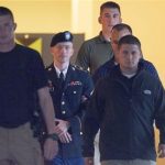 Army Pfc. Bradley Manning is escorted out of a courthouse at Fort Mead, Md, Friday, July 26, 2013. Manning is charged with indirectly aiding the enemy by sending troves of classified material to WikiLeaks. He faces up to life in prision. (AP Photo/Cliff Owen))