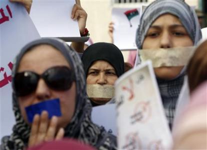 Libyan women with taped mouths take part in a silent march in support of the women who were raped during the recent war in Libya, in Tripoli in this November 26, 2011 file picture. REUTERS/Mohamed Salem/Files