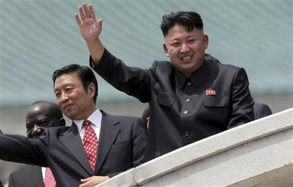 North Korea's leader Kim Jong Un, right, is accompanied by Chinese Vice President Li Yuanchao, center, and Ugandan Vice-President Edward Kiwanuka Ssekand as they greet spectators Saturday, July 27, 2013 during the mass military parade celebrating the 60th anniversary of the Korean War armistice in Pyongyang, North Korea. (AP Photo/Wong Maye-E)