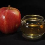 FILE - In this Sept. 15, 2011 photo, an apple and a pitcher of apple juice are posed together in Moreland Hills, Ohio. The Food and Drug Administration is setting a new limit on the level of arsenic allowed in apple juice, after more than a year of public pressure from consumer groups worried about the contaminant's effects on children. (AP Photo/Amy Sancetta, File)