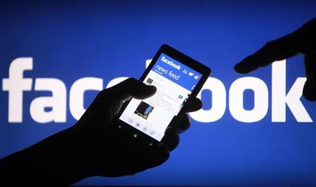 A smartphone user shows the Facebook application on his phone in the central Bosnian town of Zenica, in this photo illustration, May 2, 2013. REUTERS/Dado Ruvic