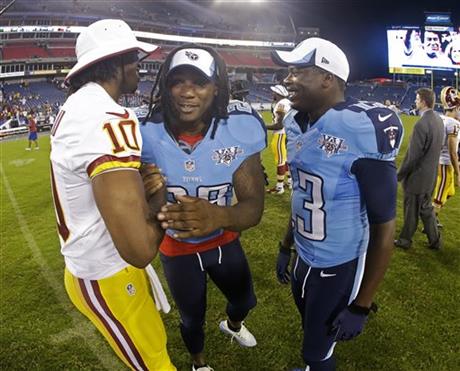 Tennessee Titans running back Chris Johnson (28) and wide receiver Kendall Wright (13) talk with Washington Redskins quarterback Robert Griffin III (10)