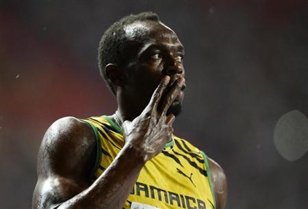 Bolt of Jamaica celebrates winning in the men's 100 metres final during the IAAF World Athletics Championships in Moscow