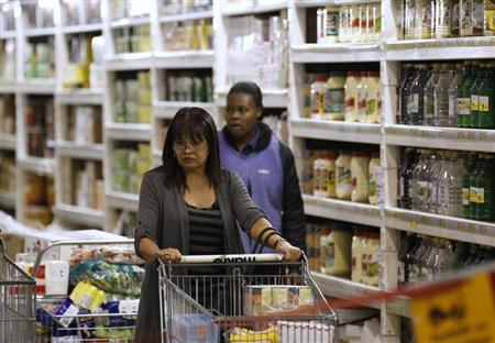 A shopper pushes a trolley of groceries at the Makro branch of South African retailer Massmart in Johannesburg