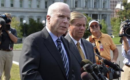 U.S. Senator McCain (R-AZ) makes remarks to the media as U.S. Senator Lindsey Graham (R-SC) listens, after meeting with U.S. President Obama at the White House in Washington