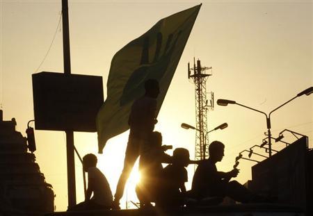 Members of the Muslim Brotherhood and supporters of ousted Egyptian President Mohamed Mursi form silhouettes during a protest near the El-Thadiya presidential palace in Cairo