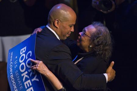 U.S. Senate candidate Cory Booker hugs his mother Carolyn after delivering a speech during his campaign's election night event in Newark, New Jersey