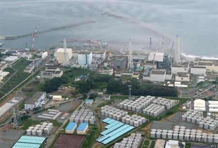 An aerial view shows TEPCO's tsunami-crippled Fukushima Daiichi nuclear power plant and its contaminated water storage tanks in Fukushima