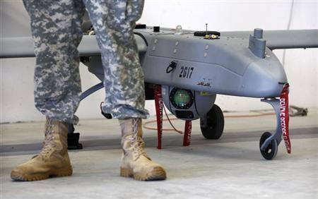 A soldier stands in front of a 'Shadow' drone during presentation by UAS at US military base in Vilseck-Grafenwoehr