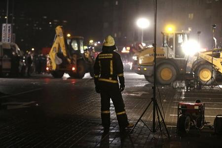 A firefighter watches the rescue operation at the site of the collapsed Maxima supermarket in Riga