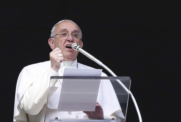 Pope Francis reacts as he conducts his Sunday Angelus prayer in Saint Peter's square at the Vatican