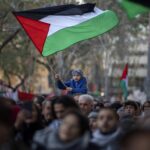 A boy waves a Palestinian flag as demonstrators march during a protest in support of Palestinians and calling for an immediate ceasefire in Gaza, in Barcelona, Spain, on Jan. 20, 2024. European Union countries Spain and Ireland as well as Norway on Wednesday announced dates for recognizing Palestine as a state.