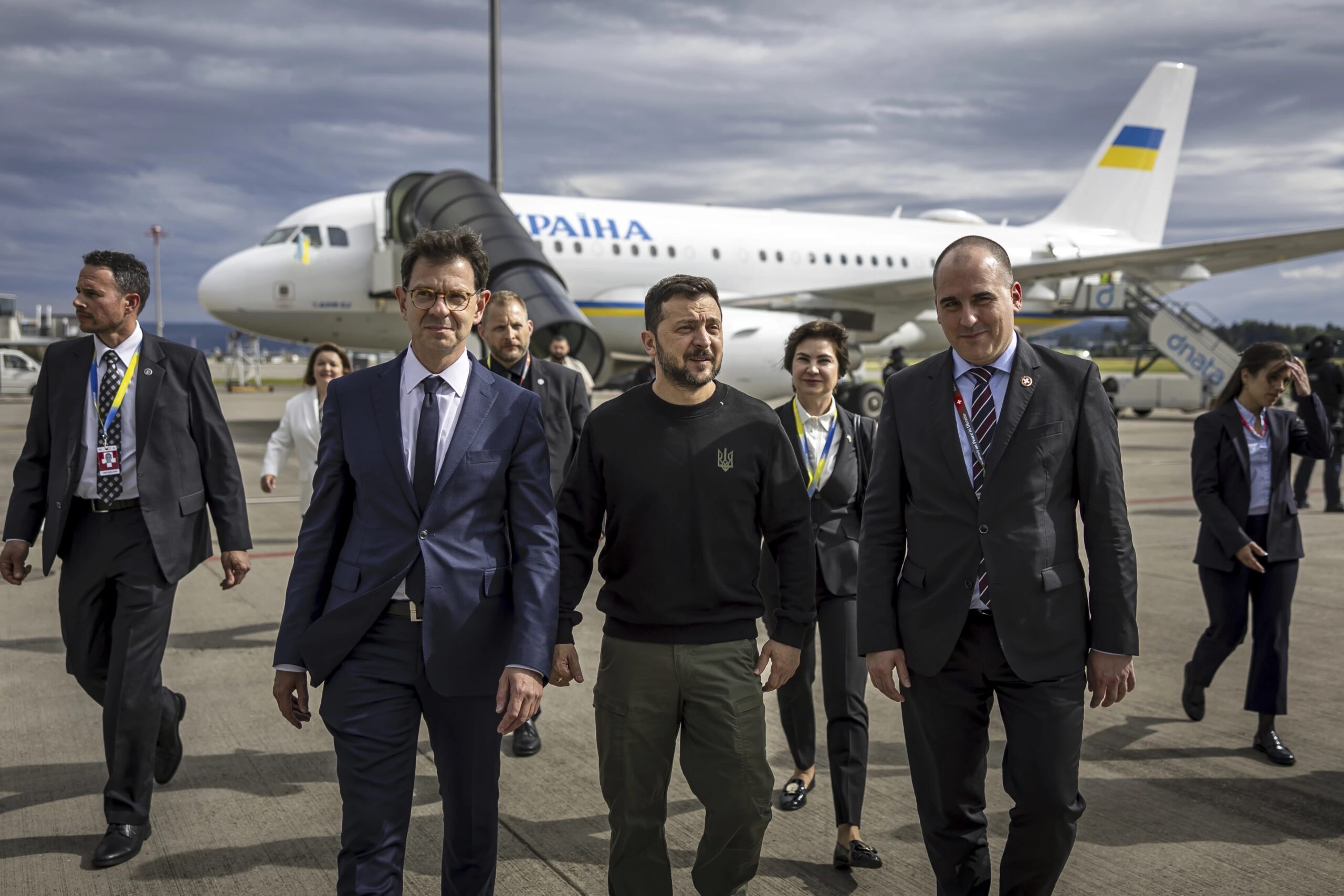 Ukraine’s President Volodymyr Zelenskyy, center, is accompanied after his arrival by Felix Baumann, Ambassador of Switzerland to Ukraine, centre left, Iryna Wenediktowa, Ukrainian Ambassador to Switzerland, second from right, and Manuel Irman, Deputy Head of Swiss Protocol, right, at Zurich airport in Zurich Kloten, Switzerland, Friday, June 14, 2024. (Michael Buholzer/Keystone via AP)
