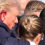 Republican presidential candidate and former President Donald Trump is surrounded by U.S. Secret Service agents as he is helped off the stage at a campaign rally in Butler, Pa., on Saturday.