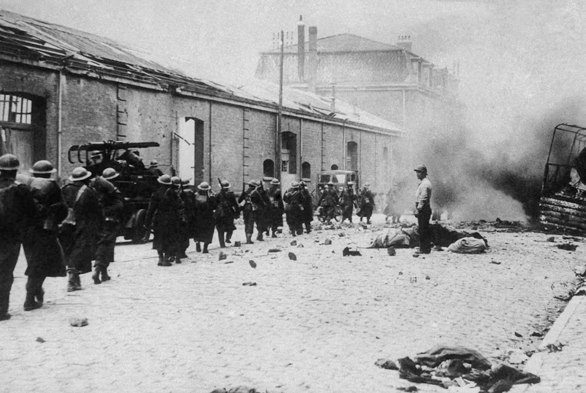 British troops march down a Dunkirk street in France on June 13, 1940, heading for the ships that will take them back to England. 