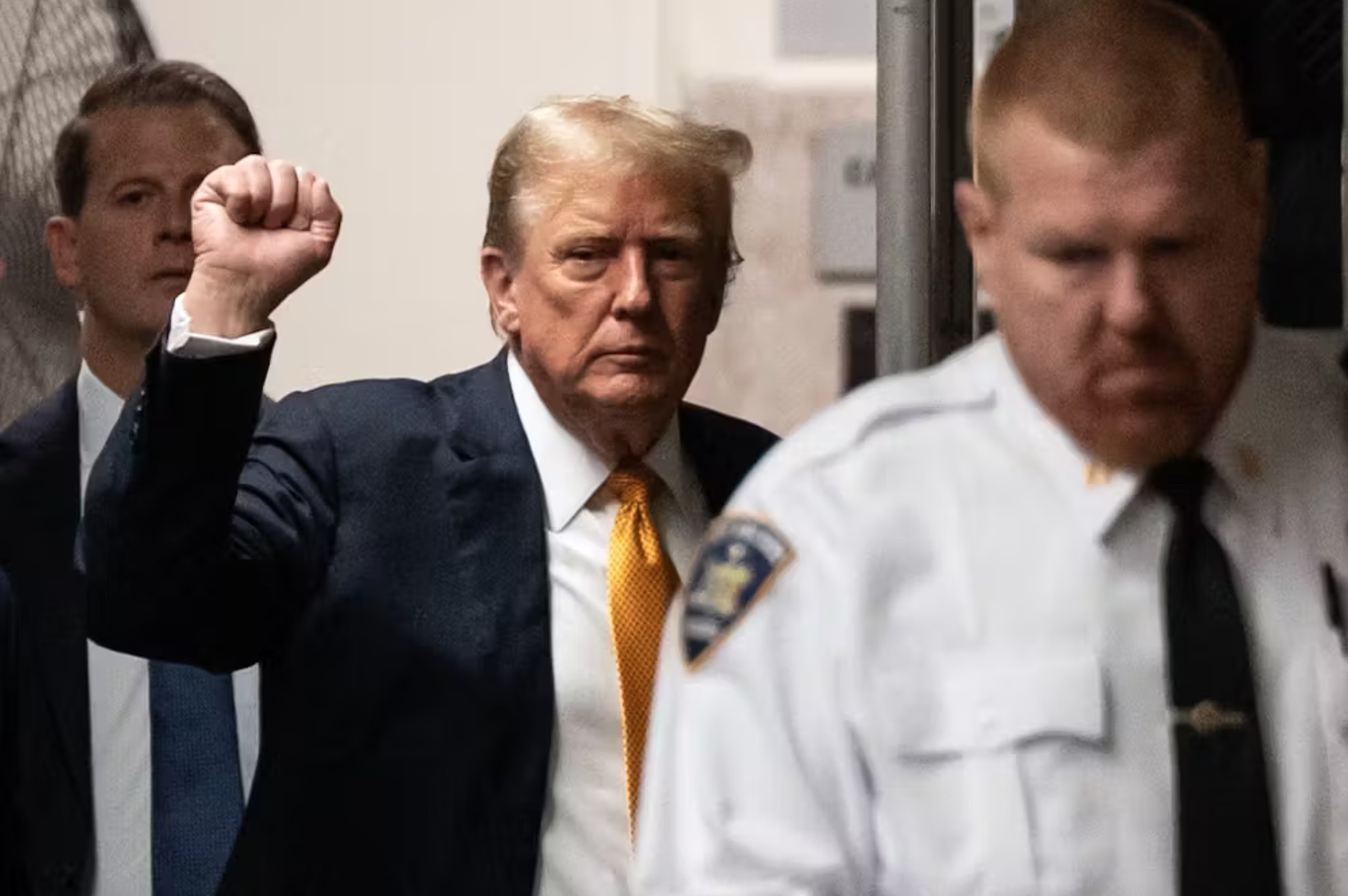 Donald Trump raises his fist as he arrives for his criminal trial at Manhattan Criminal Court in New York City on May 29, 2024