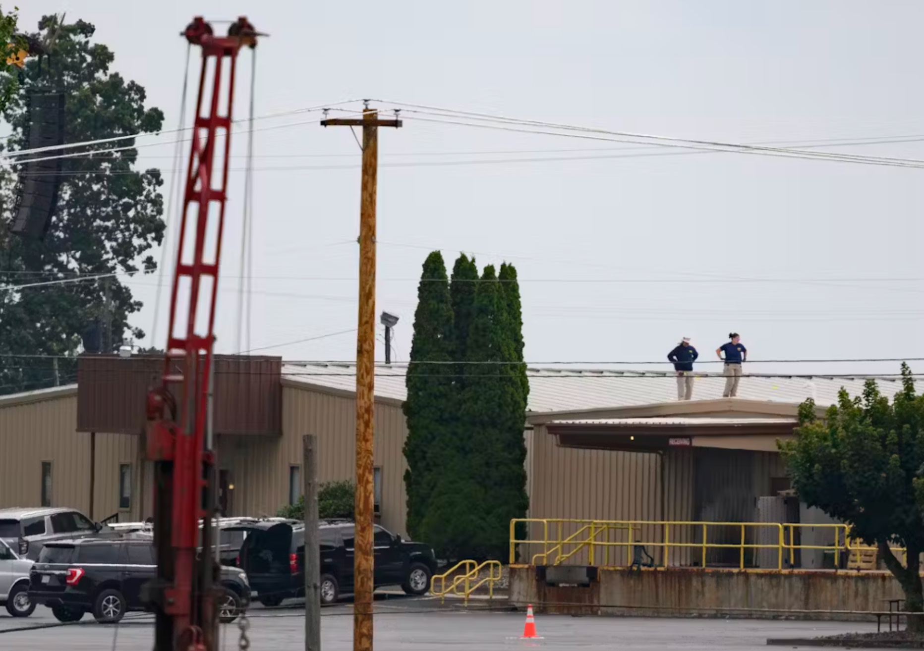 On July 14, 2024, two FBI investigators scan the roof of the building from where Matthew Thomas Crooks fired at former president Donald Trump. 