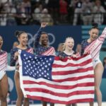 Members of Team USA celebrate after winning the gold medal in the women’s artistic gymnastics team finals round at Bercy Arena at the 2024 Summer Olympics, Tuesday, July 30, 2024, in Paris