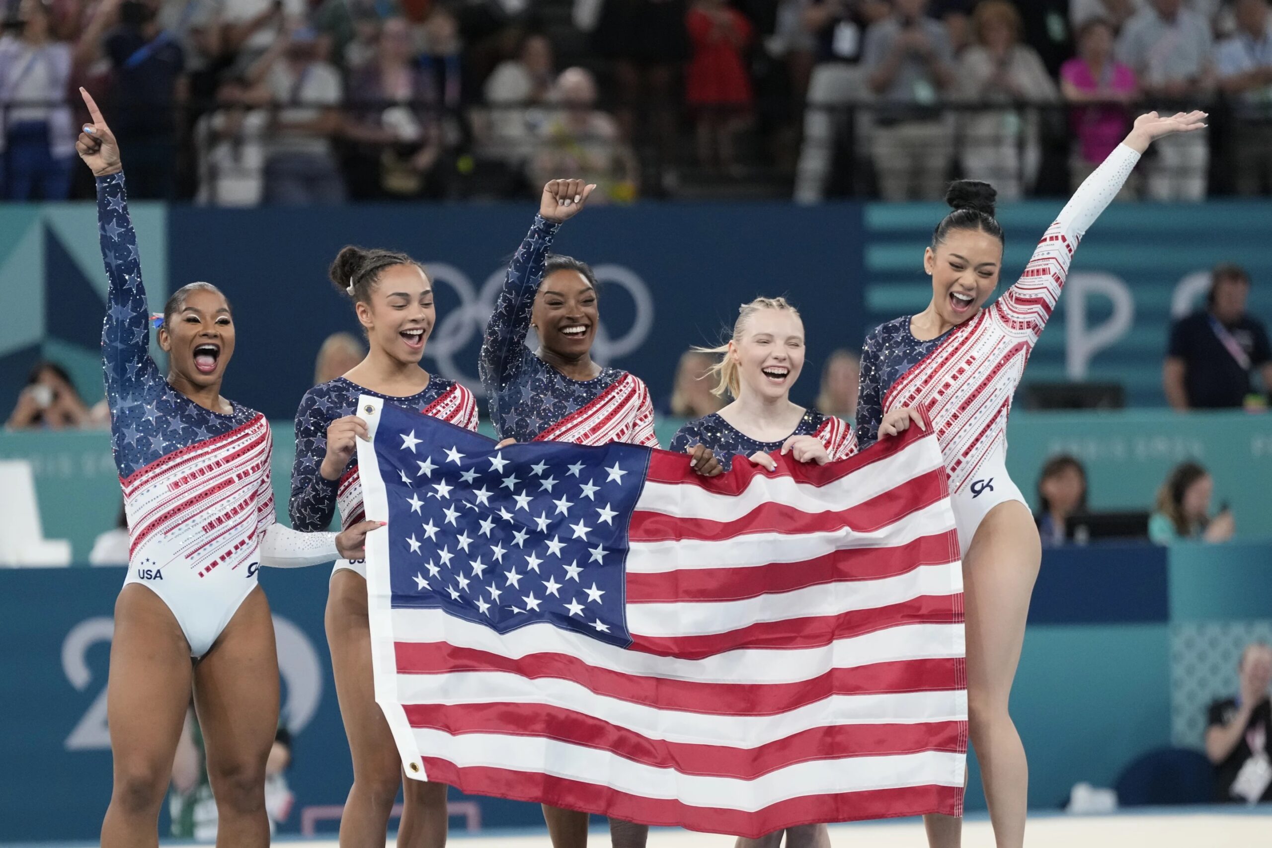 Members of Team USA celebrate after winning the gold medal in the women’s artistic gymnastics team finals round at Bercy Arena at the 2024 Summer Olympics, Tuesday, July 30, 2024