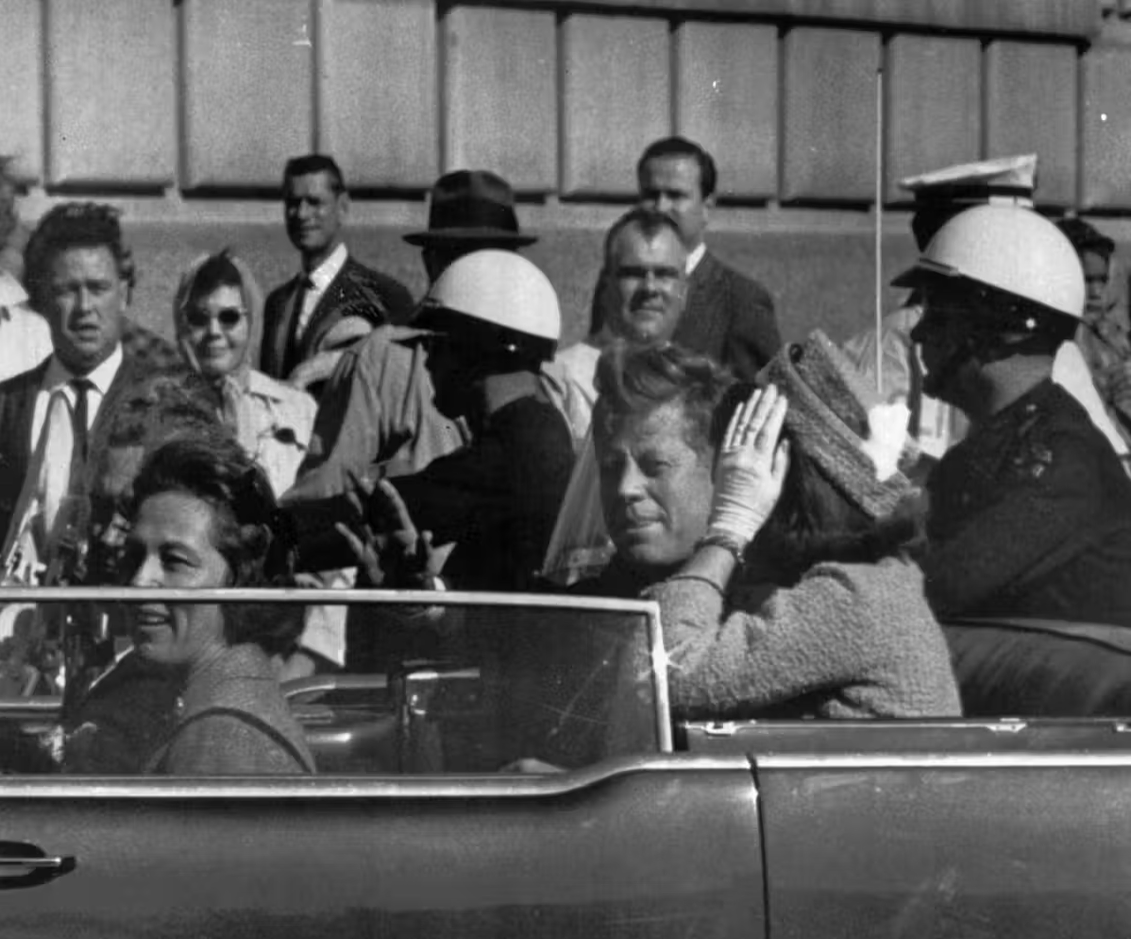 In this Nov. 22, 1963 photo, President John F. Kennedy rides in a motorcade with his wife Jacqueline moments before he was shot and killed in Dallas, Texas. 