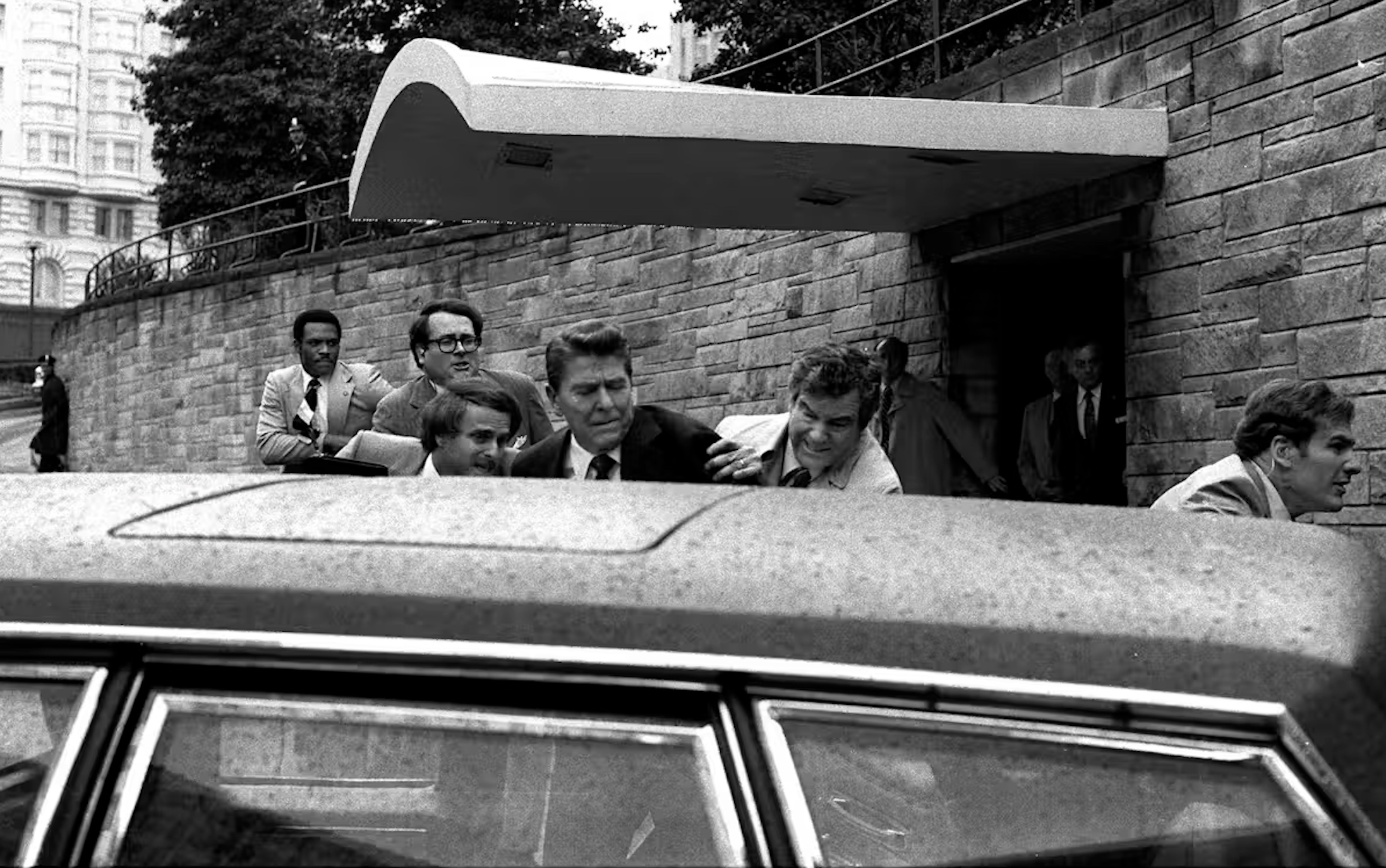 In this March 30, 1981 photo, President Ronald Reagan, center, is shown being shoved into the President’s limousine by secret service agents after being shot outside a Washington hotel.